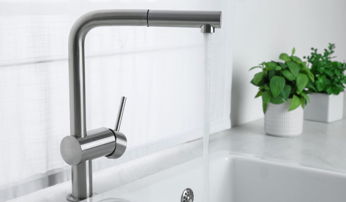 Stream of water flowing from tap in kitchen