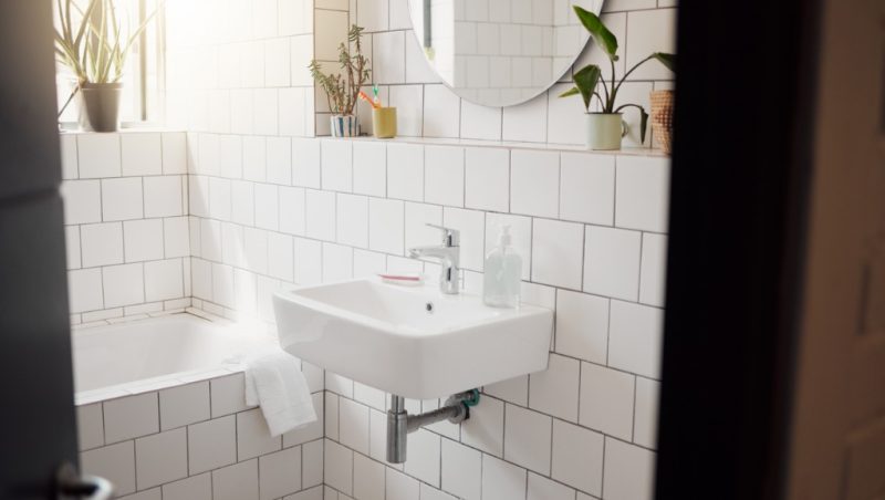 clean-and-tidy-bathroom-inside-a-house-a-basin-bath-with-ceramic-and-picture-id1403056095